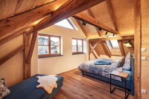 a bedroom with a bed and a couch in a attic at Haus Herzbluat in Peiting +38 photos