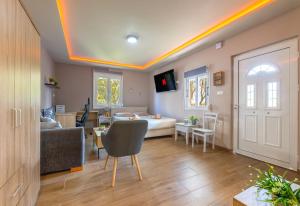 a living room with a bed and a dining room at Hot Tub - 5 min to Beaches - Private Garden - Netflix in Lampi