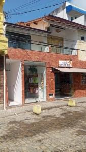 a brick building with two yellow objects in front of it at Belas Praias Itacaré 2 in Itacaré