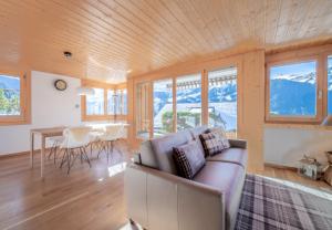a living room with a couch and a table at Chalet Sterndolde Apt 1 in Wengen