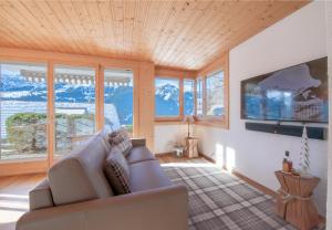 a living room with a couch and a tv at Chalet Sterndolde Apt 1 in Wengen