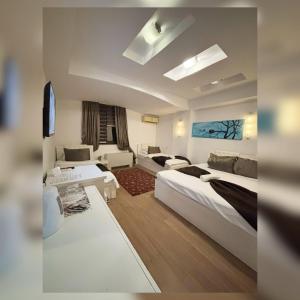 a hotel room with two beds and a couch at Theranda Hotel in Prizren +42 photos