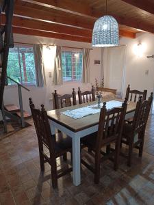 a dining room with a table and chairs at Sonidos del Rio Aparts in Santa Rosa de Calamuchita