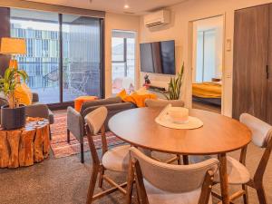 a living room with a table and chairs at Urban Retreat - 2 BDR 2 BTH Apartment in Phillip