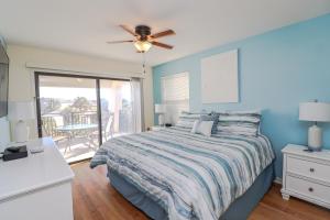 a bedroom with a bed and a ceiling fan at Island South 36 in Saint Augustine +23 photos