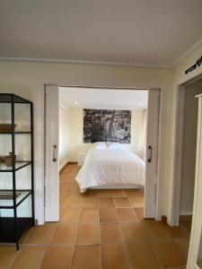 a bedroom with a white bed and a tile floor at Seaside Beach-Lounge Alicante in El Campello +38 photos