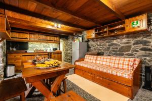 a kitchen with a table with bananas on it at King's House - Centennial House in Ribeira do Raposo +43 photos