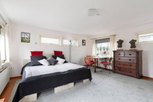 a bedroom with a bed and a desk with a dresser at Authentic Dutch Houseboat in Amsterdam Zuid in Amsterdam