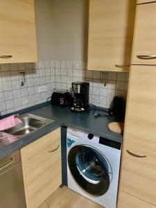 a kitchen with a washing machine and a sink at Apartment Dobias in Kelberg +7 photos