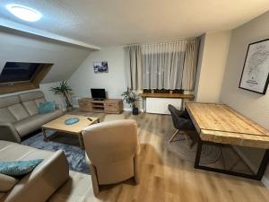 a living room with a couch and a table at Apartment Dobias in Kelberg