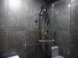a bathroom with a shower with a glass door at Nordic Hostel I Female Only I Dorms only in Phi Phi Islands +22 photos