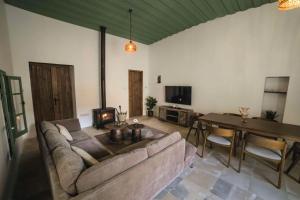 a living room with a couch and a table at Eftychia's House in Lofou