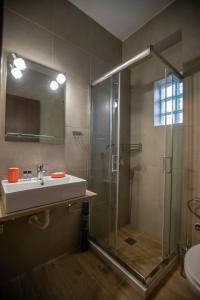 a bathroom with a glass shower and a sink at Ξαπόσταμα XAPOSTAMA - Ενοικιαζόμενα Δωμάτια in Kalyvia +71 photos