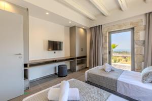 a hotel room with a bed and a tv at Villa Lefkothea in Georgioupoli +59 photos