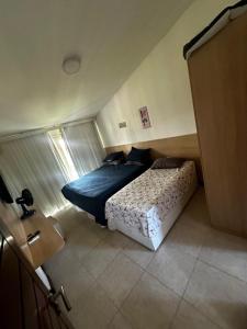 タマンダレーにあるFlat Club Meridional Praia dos Carneiros- Tamandaré/PE.のベッドと窓のある小さな寝室