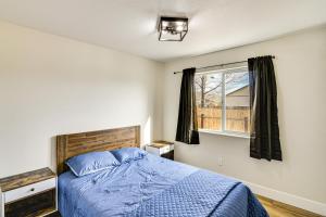 a bedroom with a blue bed and a window at 1 Mi to Pioneer Crossing Casino Fernley Retreat! in Fernley