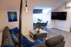 a living room with a couch and a table at Lethbridge Villa 49 Apartment 3 Super Fibre WiFi, Free parking in Southport
