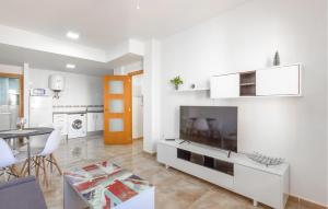 a living room with a large television and a table at Amazing Apartment In Santa Pola in Santa Pola