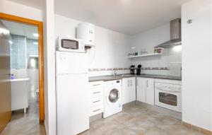 a white kitchen with a washer and dryer in it at Amazing Apartment In Santa Pola in Santa Pola