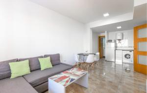 a living room with a couch and a table at Amazing Apartment In Santa Pola in Santa Pola