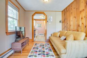a living room with a couch and a television at Walk to Grays Beach Park Kingston Seaside Escape in Kingston