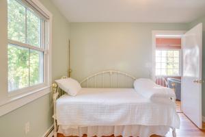 a white bed in a room with two windows at Walk to Grays Beach Park Kingston Seaside Escape in Kingston