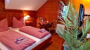 a bedroom with two beds with red and white sheets at Sonnleit'n Zimmer 2 in Abtenau