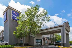 a building with a sign for a shell gas station at Sleep Inn in Lexington