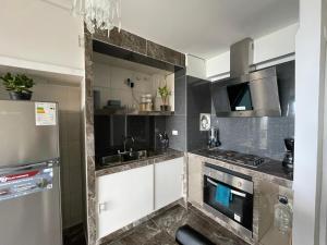 a kitchen with a sink and a stove top oven at Apartamento VistaMar in La Guaira +2 photos
