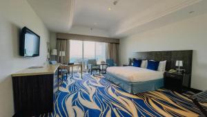 a hotel room with a bed and a television at Mirfa Hotel in Al Mirfa +37 photos