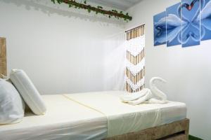 a bedroom with a bed with two white swans on it at Hostal barú in Bolivar