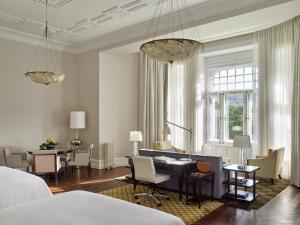 a living room with a table and a dining room at Four Seasons Hotel Gresham Palace Budapest in Budapest