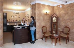 two women standing at a counter in a room at Kalasi Hotel in Tbilisi City