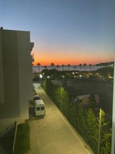 a view of a parking lot with a van parked at JL apartament tirana resort in Radhimë