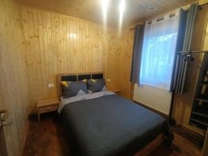 a bedroom with a bed and a window in it at Casa La Măriuca in Bran +25 photos