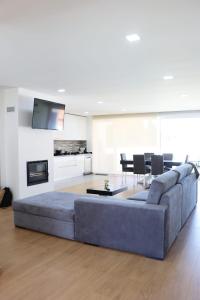 a living room with a large couch and a table at Villa Casa Carlotti in Ponte de Vagos