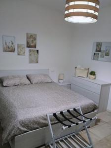 una camera da letto con un letto in una stanza bianca di Casa Viola Lazise lago e relax! a Lazise