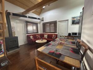 a living room with a table and a couch at Cherry Holiday House in Khandria