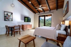 a bedroom with a bed and a table and chairs at River Park Hotel in Puerto Vallarta