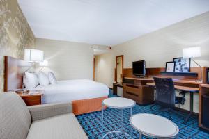 a hotel room with a bed and a desk at Fairfield Inn Portsmouth Seacoast in Portsmouth +18 photos