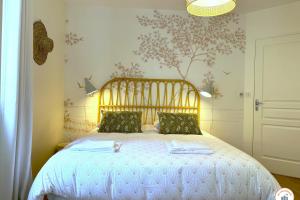 a bedroom with a bed with two towels on it at Le Cosy - Vue Mer - Parking - Balcon in Le Havre