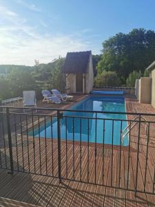 a swimming pool with a metal fence around it at La Bastide des Chézeaux - Brenne in Rivarennes