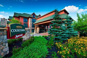a hotel with a sign in front of a building at Courtyard Marriott Lake Placid in Lake Placid