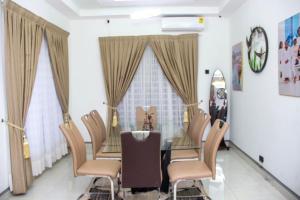 a dining room with a table and chairs at Kenest Villa, Oyarifa Estate - Accra Gh in Oyarifa