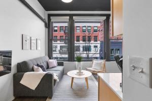 a living room with a couch and a table at Upscale Apartment Suite - Close to Everything in Spokane