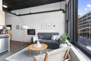 a living room with a couch and a table at Upscale Apartment Suite - Close to Everything in Spokane