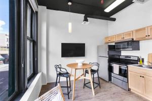 a kitchen with a small table and chairs in a room at Upscale Apartment Suite - Close to Everything in Spokane