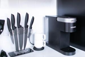 a counter with a knife block and a coffee maker at Upscale Apartment Suite - Close to Everything in Spokane