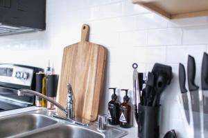 a kitchen counter with a sink and a knife block at Upscale Apartment Suite - Close to Everything in Spokane