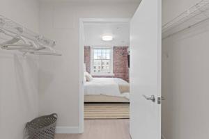 a white bedroom with a bed and a window at King Bed J and K on Main Luxury Apartment 402 in Spokane